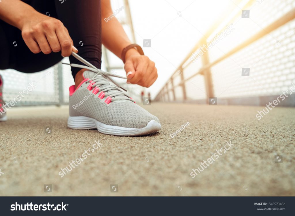 stock-photo-female-sport-fitness-runner-getting-ready-for-jogging-outdoors-on-way-1518573182